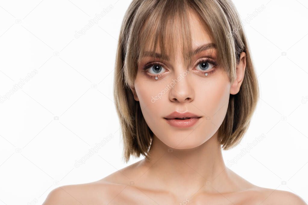 pretty young woman with bangs and decorative rhinestones under blue eyes isolated on white