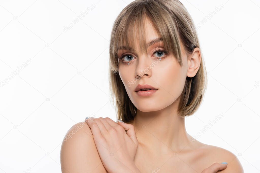 pretty young woman with bare shoulders and shiny rhinestones under blue eyes isolated on white