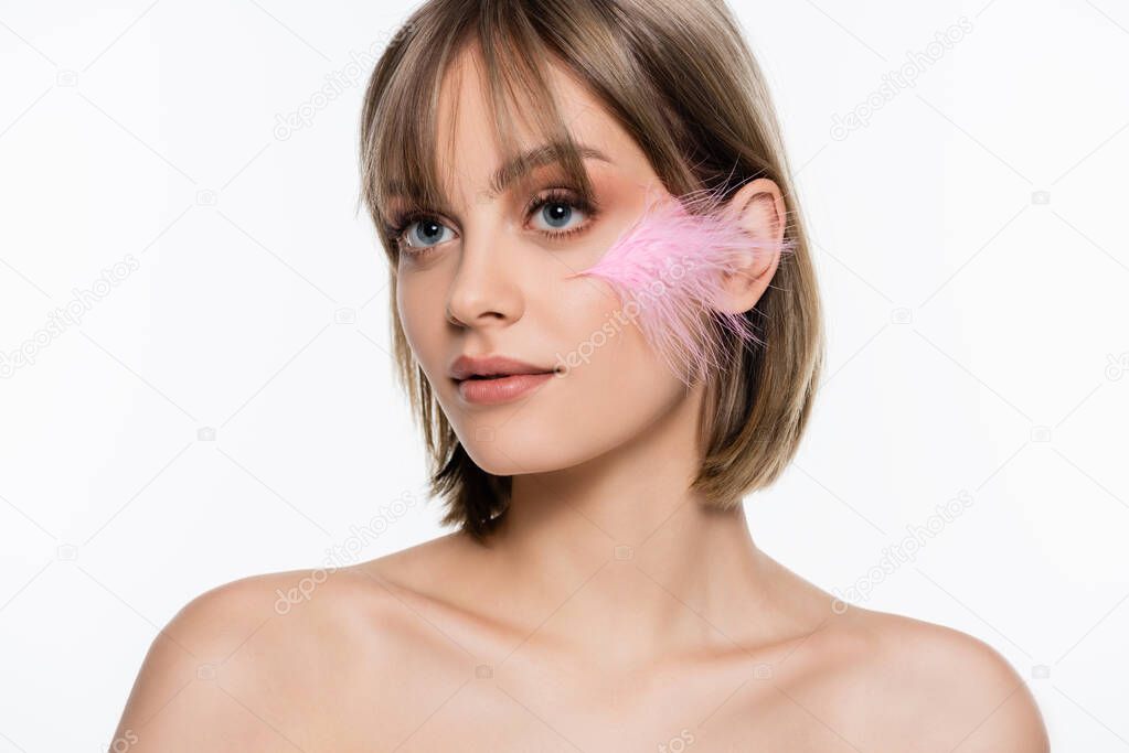 young woman with blue eyes and pink feather on face isolated on white