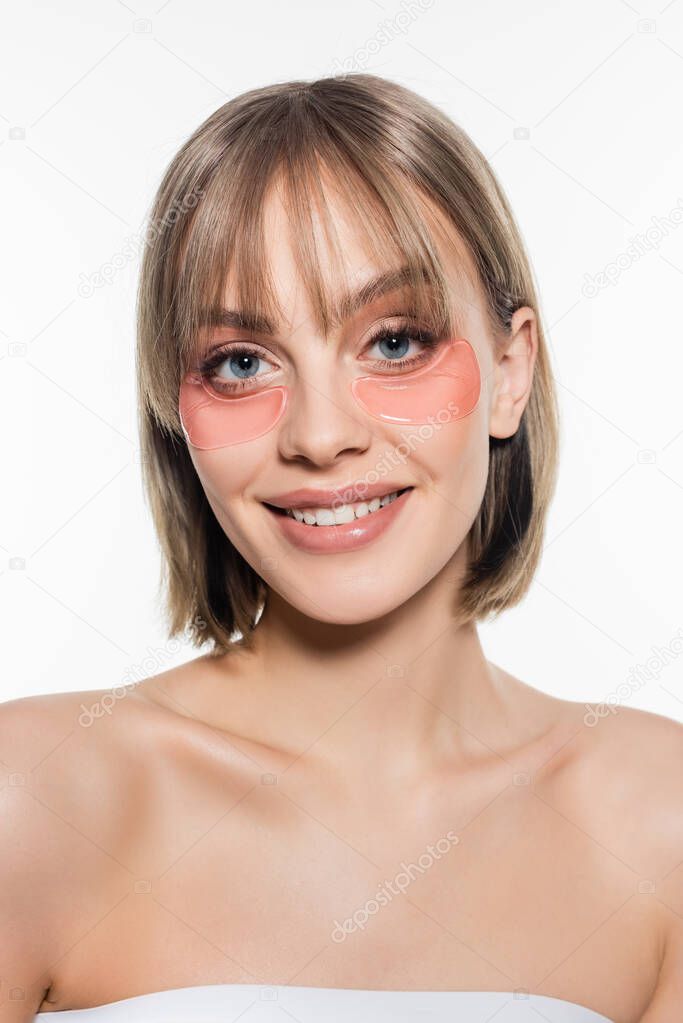 cheerful young woman with hydrogel eye patches isolated on white