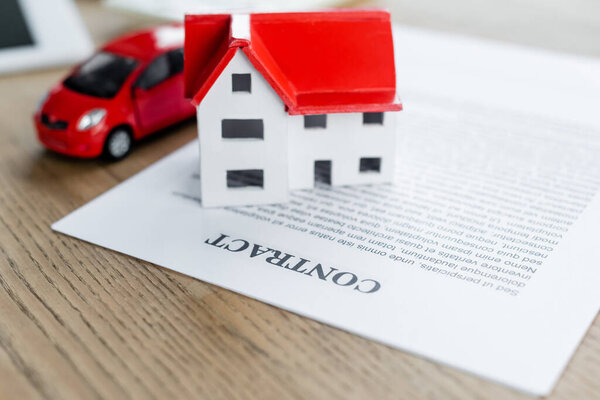 house model and toy car on contract, tax inspection concept