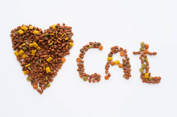 top view of heart and cat lettering made of dry pet food isolated on white