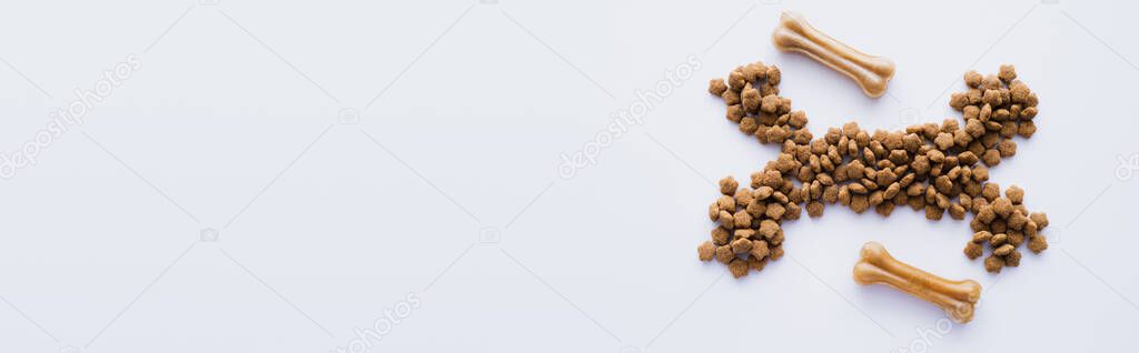 top view of bones and dry pet food isolated on white, banner