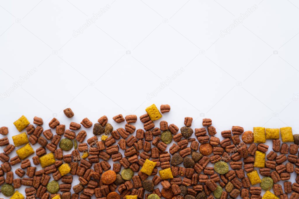 flat lay of crunchy dry pet food isolated on white with copy space