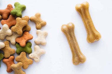 top view of crunchy bone shaped cookies and treats for dog isolated on white clipart