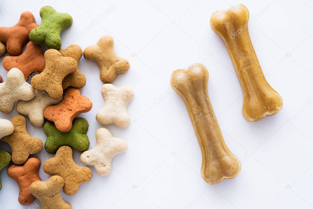 top view of crunchy bone shaped cookies and treats for dog isolated on white