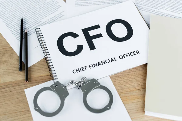 High Angle View Notebook Cfo Lettering Handcuffs Documents Desk — Stock Photo, Image