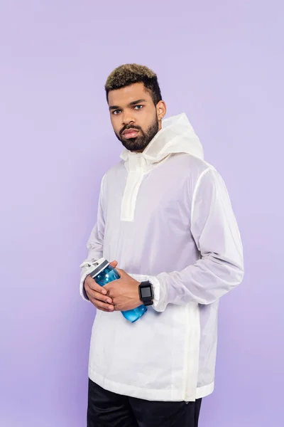 African American Man Trendy Sportswear Holding Sports Bottle Isolated Purple — Stok Foto