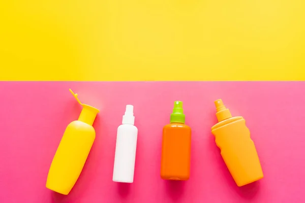 Top View Bottles Sunscreens Yellow Pink Background — Stock Photo, Image
