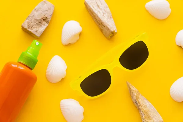 Top View Sunscreen Sunglasses Seashells Yellow Background — Stock Photo, Image