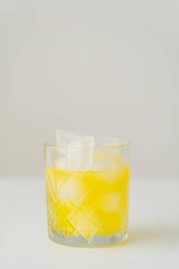 glass with fresh citrus tonic and ice cubes on grey background with copy space clipart