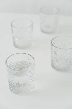 high angle view of glasses with clean water on grey blurred background clipart