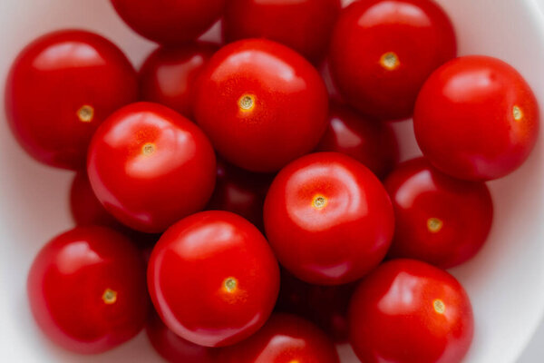 Close up view of ripe cherry tomatoes in bowl 