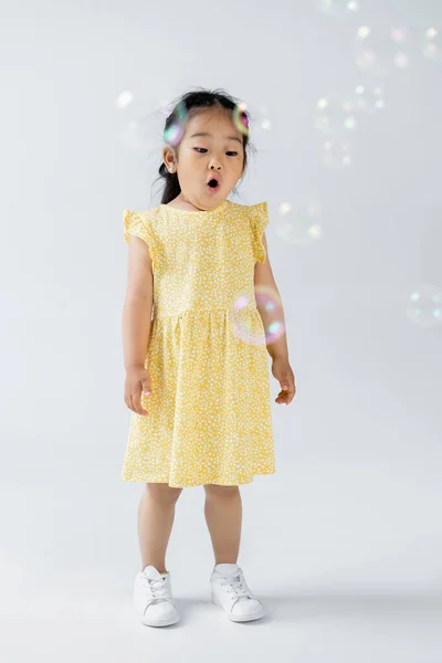 Full Length Shocked Asian Preschooler Girl Yellow Dress Standing Soap — Stock Photo, Image