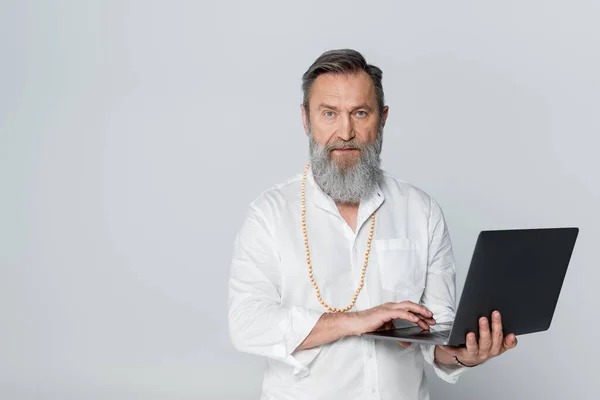 Confident Spiritual Mentor Holding Laptop Looking Camera Isolated Grey — Stock Photo, Image