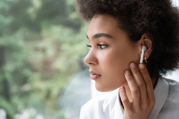 Sad African American Woman White Shirt Wireless Earphone Looking Window — Stock Photo, Image