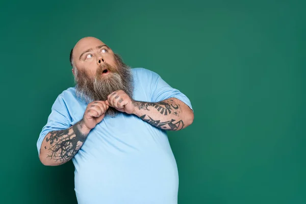 Scared Overweight Man Beard Looking Away Isolated Green — Stockfoto