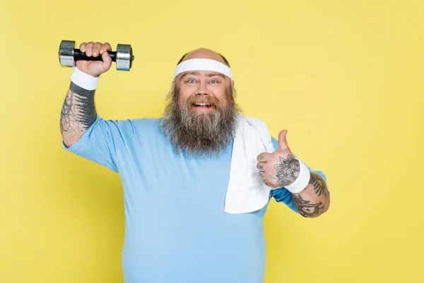 Cheerful Size Man Showing Thumb While Exercising Dumbbell Isolated Yellow — Stock Fotó