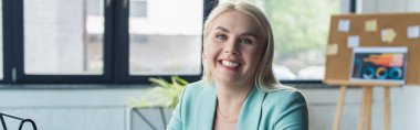 Blonde psychologist looking at camera in consultation room, banner 