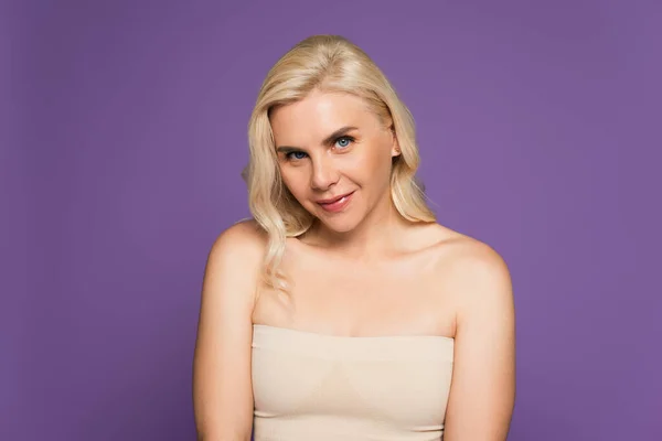 Smiling Blonde Woman Bare Shoulders Looking Camera Isolated Purple — Stockfoto