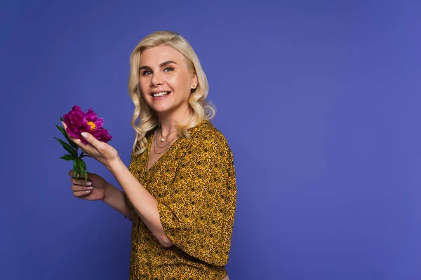 Positive Woman Blouse Holding Purple Flower Green Leaves Isolated Violet — Foto de Stock