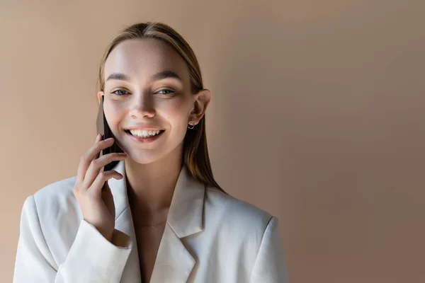 Trendy Woman Smiling Camera While Talking Mobile Phone Isolated Grey — Stock Photo, Image