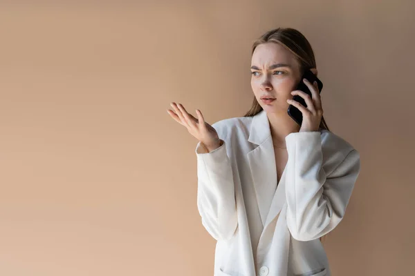 Displeased Woman Talking Cellphone Pointing Hand Isolated Beige — Foto de Stock