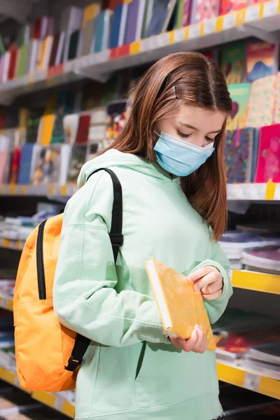Girl Medical Mask Holding New Copybook Blurred Store — Stock Fotó