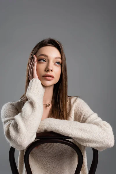 Dreamy Woman Holding Hand Face Looking Away While Sitting Chair — Fotografia de Stock