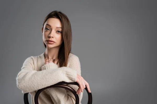 Brunette Woman Warm Sweater Looking Camera While Posing Chair Isolated — стоковое фото