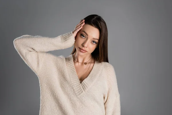 Young Brunette Woman Soft Sweater Touching Head Looking Camera Isolated — Φωτογραφία Αρχείου