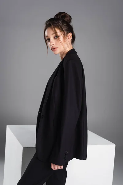 Young Stylish Woman Makeup Standing Black Blazer White Cube Isolated — Fotografia de Stock