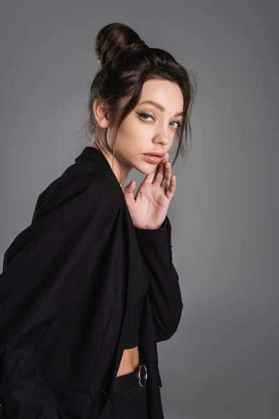 Pretty Woman Black Jacket Holding Hand Face Looking Camera Isolated — Stockfoto