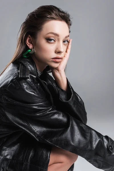 Brunette Woman Black Leather Coat Touching Face Looking Camera Isolated — Stock fotografie