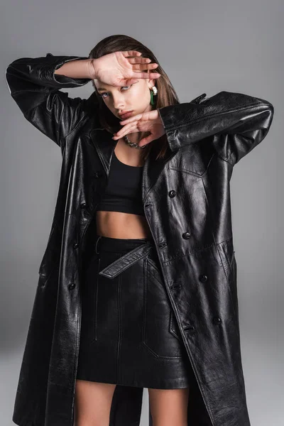 Trendy Woman Leather Skirt Black Coat Holding Hands Face Isolated — ストック写真