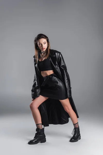 Full Length Woman Black Leather Skirt Coat Looking Away While — стоковое фото