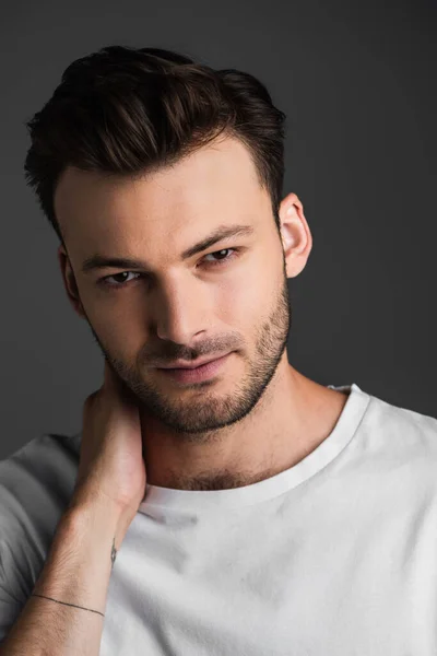 Portrait Young Brunette Man Looking Camera While Touching Neck Isolated — Foto de Stock