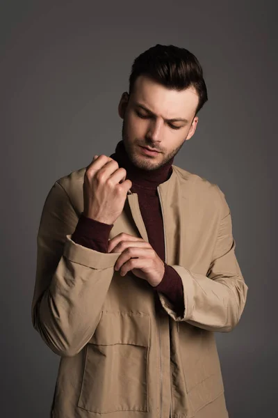 Brunette Man Adjusting Sleeve Autumn Jacket Isolated Grey — Foto de Stock