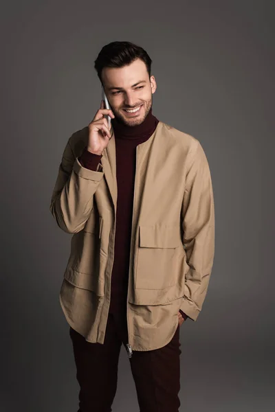 Stylish Smiling Man Jacket Talking Smartphone Isolated Grey — Stockfoto