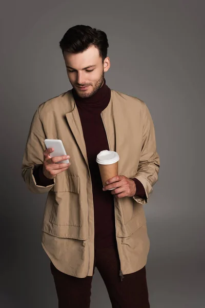 Brunette Man Autumn Jacket Holding Paper Cup Using Smartphone Isolated — 스톡 사진