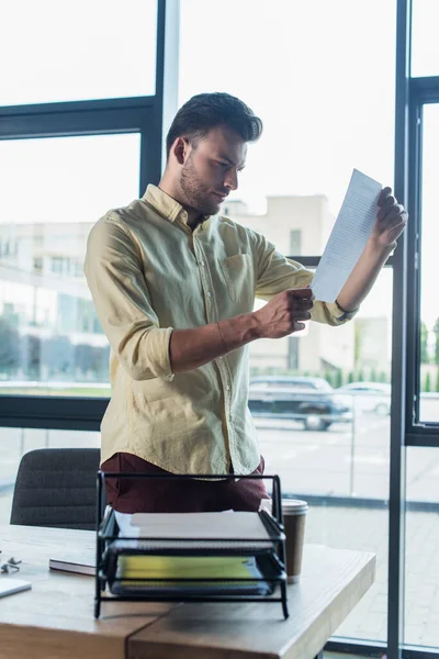 Businessman Looking Document Coffee Papers Office — Foto de Stock