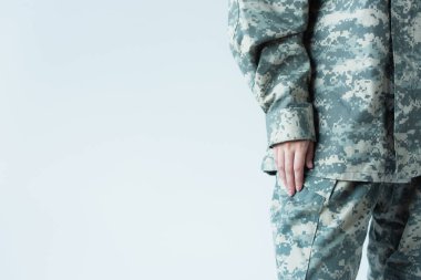 Cropped view of woman in military uniform standing isolated on grey 