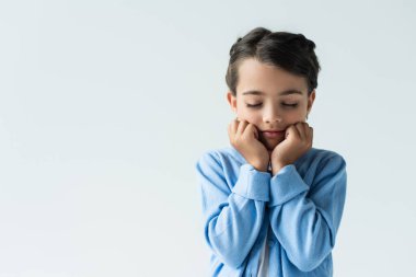 frustrated girl with closed eyes holding hands near face isolated on grey, banner