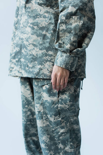 Cropped view of servicewoman in camouflage uniform standing isolated on grey 