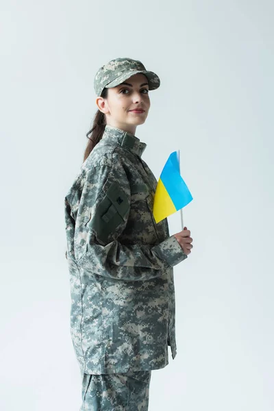 Young Servicewoman Holding Ukrainian Flag Isolated Grey — стоковое фото