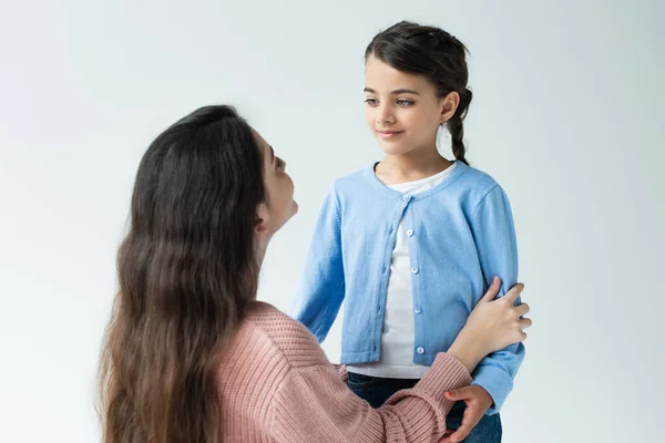 Smiling Girl Looking Mother Hugging Her Isolated Grey — Stockfoto