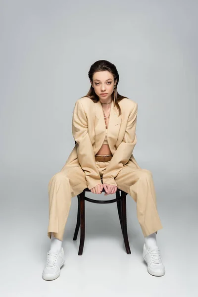 Full Length Stylish Woman Beige Outfit Looking Camera While Sitting —  Fotos de Stock