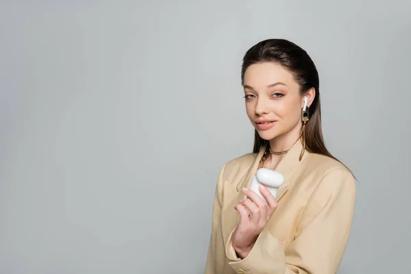 Cheerful Woman Stylish Outfit Holding Plastic Case While Listening Music — Stock Fotó