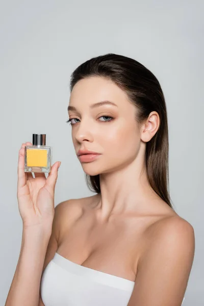 Pretty Woman Bare Shoulders Holding Bottle Luxury Perfume Isolated Grey — Stock fotografie