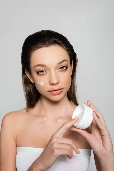 Brunette Woman Bare Shoulders Cream Face Holding Container Isolated Grey — Φωτογραφία Αρχείου